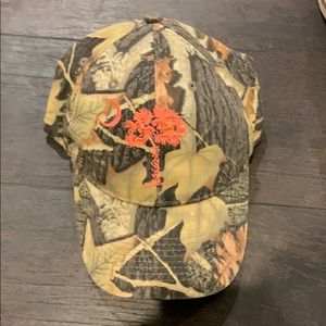 Camo hat with south carolina logo on it